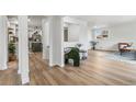 Bright living room with hardwood floors, fresh paint, and a view into an updated kitchen at 1155 W 4Th Ave, Broomfield, CO 80020