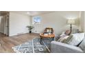 Cozy living room with bright window, comfortable seating, and stylish rug at 1155 W 4Th Ave, Broomfield, CO 80020