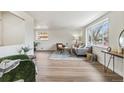 Bright living room featuring hardwood floors, large windows, and neutral decor creates a welcoming atmosphere at 1155 W 4Th Ave, Broomfield, CO 80020