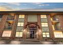 Multi-story brick building with symmetrical facade, balconies, decorative lighting and an arched entryway at 1021 Carr St # 37, Lakewood, CO 80214