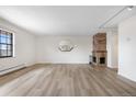 Spacious living room with a cozy brick fireplace and lots of natural light at 1021 Carr St # 37, Lakewood, CO 80214