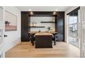 A stylish office offers built-in shelving, ample natural light, and modern decor at 555 Coal Bank Trl, Castle Rock, CO 80104