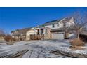 Charming two-story home featuring a three-car garage, stone accents, and a welcoming front porch at 226 N Millbrook St, Aurora, CO 80018