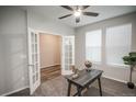 Carpeted bedroom featuring ample light, fan, and glass paneled french doors at 17600 Rose Heath Ln, Parker, CO 80134