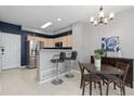 Kitchen and dining area with stainless steel appliances and bar seating at 5555 E Briarwood Ave # 1404, Centennial, CO 80122