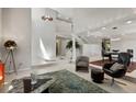 Open concept living room boasts high ceilings and plenty of natural light at 15207 W Ellsworth Pl, Golden, CO 80401