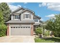 Charming exterior view of a well-maintained two-story home with a two-car garage and beautiful landscaping at 15948 E 106Th Pl, Commerce City, CO 80022