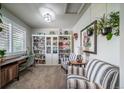 Bright office space featuring built-in bookshelves, a desk, and comfortable seating area at 21502 E Idyllwilde Dr, Parker, CO 80138
