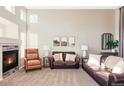 Spacious living area featuring a cozy fireplace and comfortable seating at 4128 S Riviera St, Aurora, CO 80018