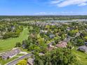 Expansive aerial view of the community, showcasing lush greenery, lake, and neighborhood at 78 Fairway Ln, Littleton, CO 80123