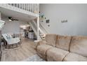 Open living space with loft, showing a modern kitchen, and a large comfy sofa at 1885 S Quebec Way # D22, Denver, CO 80231