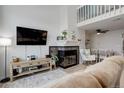Cozy living room with fireplace, lots of natural light and open floor plan to dining area at 1885 S Quebec Way # D22, Denver, CO 80231