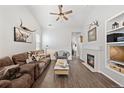 This inviting living room features hardwood floors, a cozy fireplace, and stylish decor at 5428 Suffolk Ave, Castle Rock, CO 80104