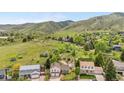 Picturesque aerial view of a home nestled amidst lush greenery and rolling hills at 229 Berthoud Way, Golden, CO 80401