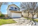 A view of an attractive house with a stone facade and a large two-car garage on a sunny day at 8050 Bryant St, Westminster, CO 80031