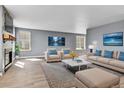 Bright living room features wood-look tile floors, a modern fireplace, and stylish furnishings at 8050 Bryant St, Westminster, CO 80031