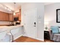 Bright entryway with hardwood floors, modern kitchen view, and living room details at 10056 W Unser Dr # 106, Littleton, CO 80127