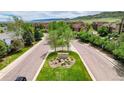 Street view featuring the community entrance sign and tree-lined streets at 10056 W Unser Dr # 106, Littleton, CO 80127