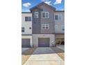 New construction home with two-car garage and a concrete driveway at 6840 Merseyside Ln, Castle Pines, CO 80108