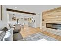 Bright and open living room with hardwood floors, fireplace, and an open floorplan to the kitchen at 2701 Barnhart St, Thornton, CO 80229