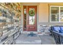 A warm and inviting front entrance of a home, adorned with a decorative wreath on the front door at 791 Elk Rest Rd, Evergreen, CO 80439