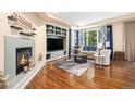 Bright living room with a cozy fireplace, custom built-ins and plush seating area, perfect for Gathering gatherings at 12051 E Lake Cir, Greenwood Village, CO 80111