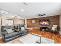 Inviting living room features a wooden accent wall, hardwood floors, and comfortable leather seating at 12901 2Nd St, Parker, CO 80134