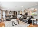 Spacious living room with hardwood floors and a seamless connection to the kitchen at 12901 2Nd St, Parker, CO 80134
