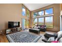 Spacious living room with hardwood floors and large windows at 9696 E Sand Lily Ln, Parker, CO 80134