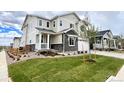 Charming home featuring a welcoming porch, well-maintained lawn, and a two-car garage at 24798 E 40Th Ave, Aurora, CO 80019