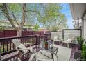Relaxing back patio with comfortable chairs, a table, and a view of the surrounding greenery at 5252 W 68Th Ave, Arvada, CO 80003