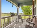 Inviting front porch with comfortable seating, perfect for enjoying the views and relaxing outdoors at 7485 S Jackson Gap Way, Aurora, CO 80016
