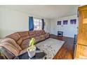 Bright and airy living room with hardwood floors, a brown sectional couch, and plenty of space at 8520 Franklin Dr, Denver, CO 80229