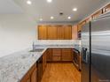 Charming kitchen features stainless appliances and beautiful granite countertops at 6000 W Floyd Ave # 105, Denver, CO 80227