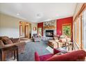 Cozy living room with a stone fireplace, comfortable seating, and large windows offering natural light at 278 Snowshoe Cir, Breckenridge, CO 80424