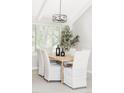Bright dining room showcasing a modern chandelier, a wooden table, and seating for six at 4821 W 102Nd Ave, Westminster, CO 80031