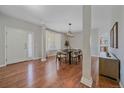 Dining room featuring hardwood floors, light fixture, and large window at 23298 Barnsley Ln, Parker, CO 80138