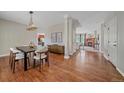 Inviting dining room featuring hardwood floors, modern light fixture, and neutral decor at 23298 Barnsley Ln, Parker, CO 80138