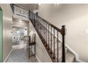 Bright foyer with staircase featuring wood railing and carpeted steps at 2757 Stallion Way, Mead, CO 80542