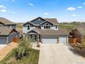 Charming two-story home boasts a manicured lawn and an attached two-car garage at 2757 Stallion Way, Mead, CO 80542