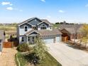 Beautiful two-story home boasting a large driveway, manicured lawn, and attractive facade at 2757 Stallion Way, Mead, CO 80542