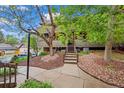 Entrance view with landscaped yard, sidewalk, mature tree and stairs leading to entry at 3050 W 32Nd Ave # 104C, Denver, CO 80211