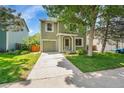 Exterior of the home showing the driveway, front lawn, and well-maintained landscaping that enhance the property's appeal at 4267 W Kenyon Ave, Denver, CO 80236