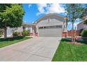 Beautiful single-Gathering home with a two-car garage, mature trees, and a well-manicured lawn at 5740 S Tempe Ct, Aurora, CO 80015