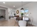 Open-concept dining area flowing into living room, filled with natural light at 4910 Alcott St, Denver, CO 80221