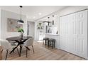 Stylish, light-filled open concept kitchen featuring modern white cabinets at 4910 Alcott St, Denver, CO 80221