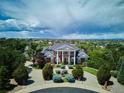 Grand estate with circular driveway and lush landscaping in an established neighborhood at 8717 Ridgepoint Dr, Castle Pines, CO 80108