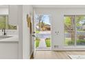 Bright entryway with white walls, modern finishes and front yard view at 1327 E 108Th Pl, Northglenn, CO 80233