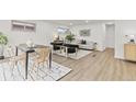Stylish living and dining area with modern decor and light wood flooring at 1327 E 108Th Pl, Northglenn, CO 80233