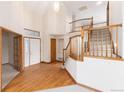 Bright foyer featuring hardwood floors, a staircase, and soaring ceilings at 15565 Flowerhill Cir, Parker, CO 80134